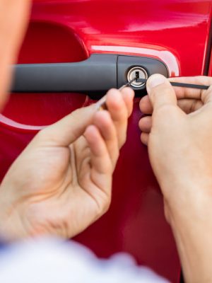 Close-up Of Person's Hand Opening Car Door With Lockpicker